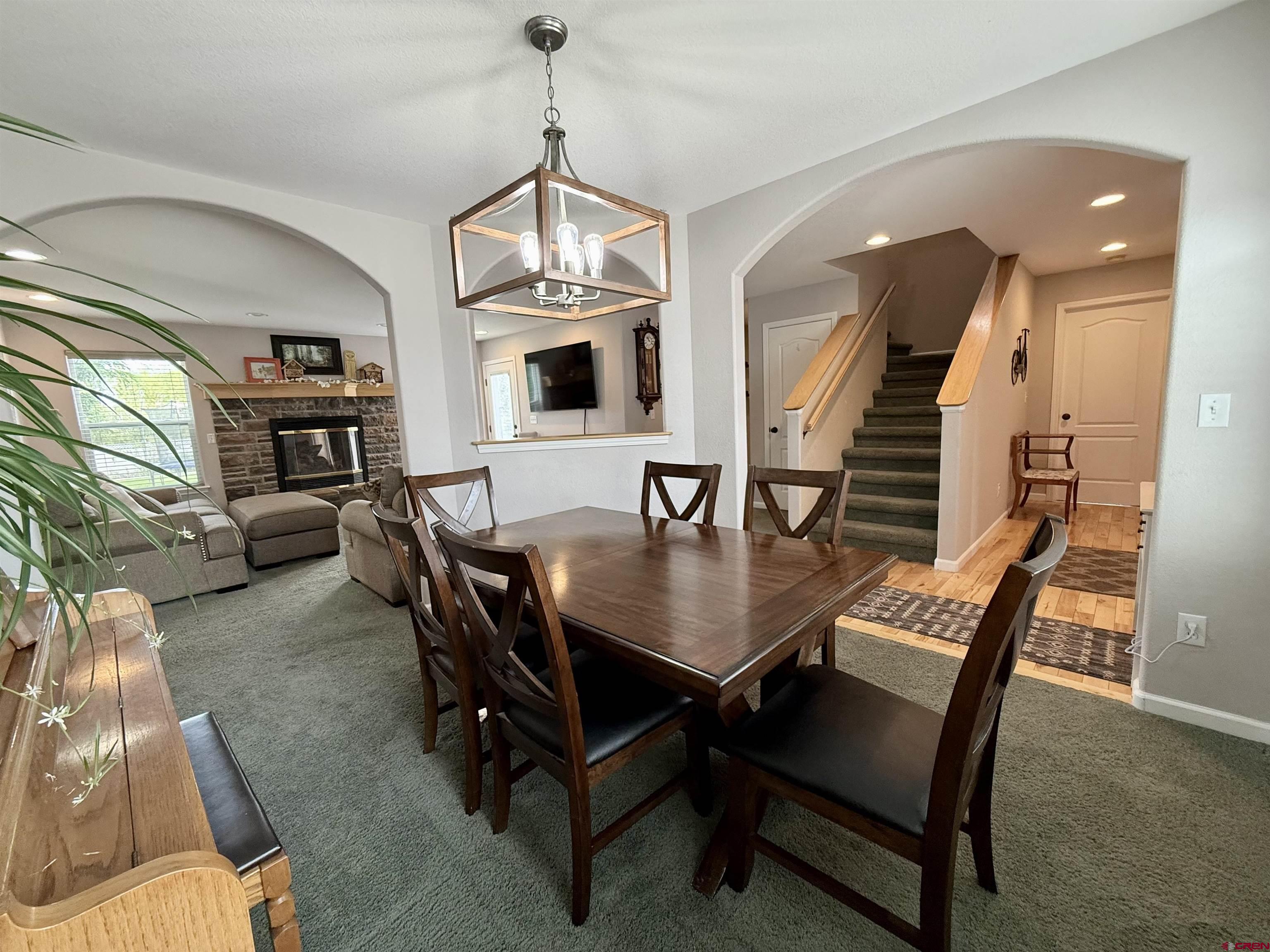 2941 Lost Creek Road North Montrose, CO 81401 - Photo 17 of 45 a dining room with furniture a chandelier and wooden floor