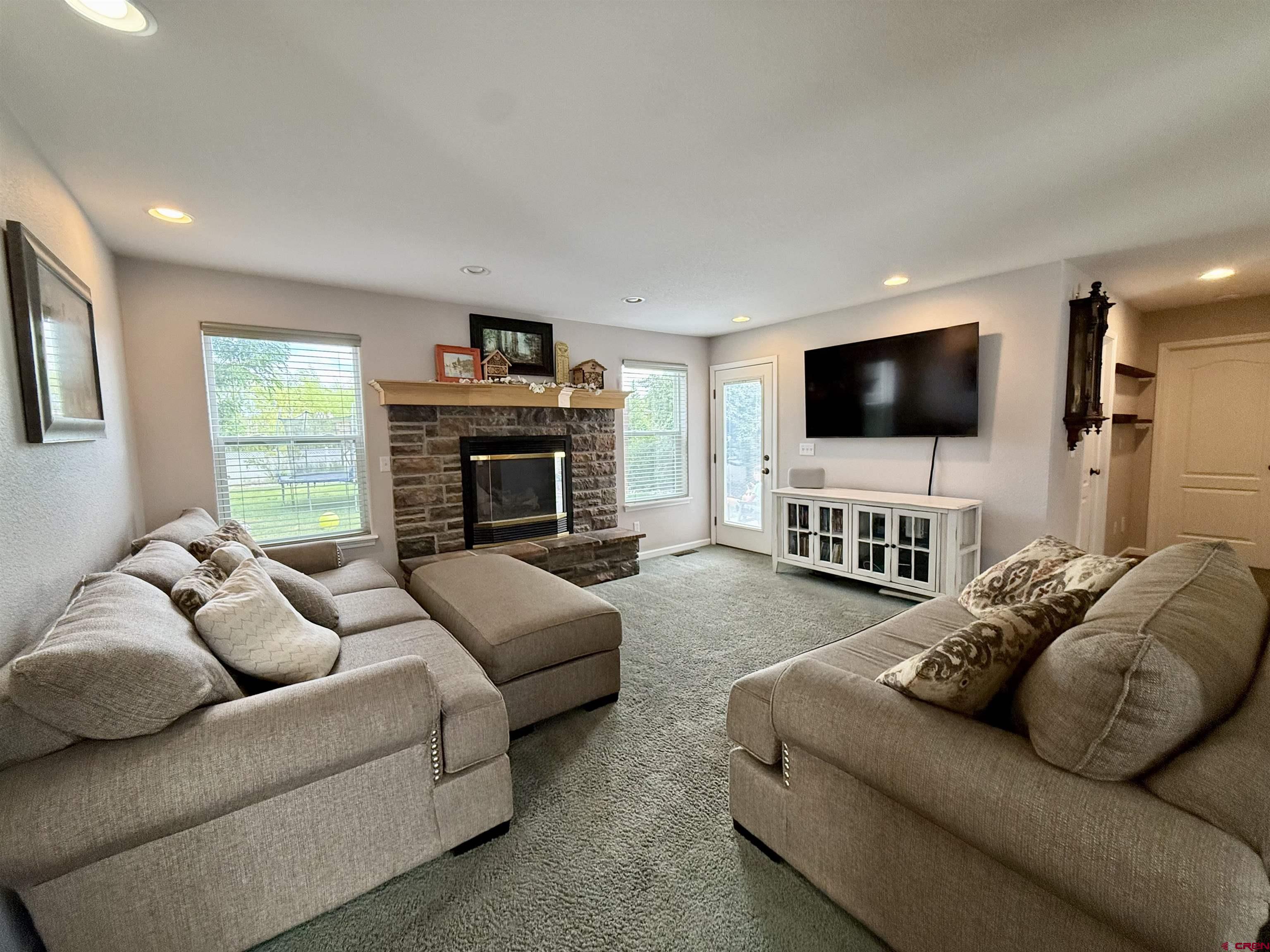 2941 Lost Creek Road North Montrose, CO 81401 - Photo 18 of 45 a living room with furniture and a flat screen tv