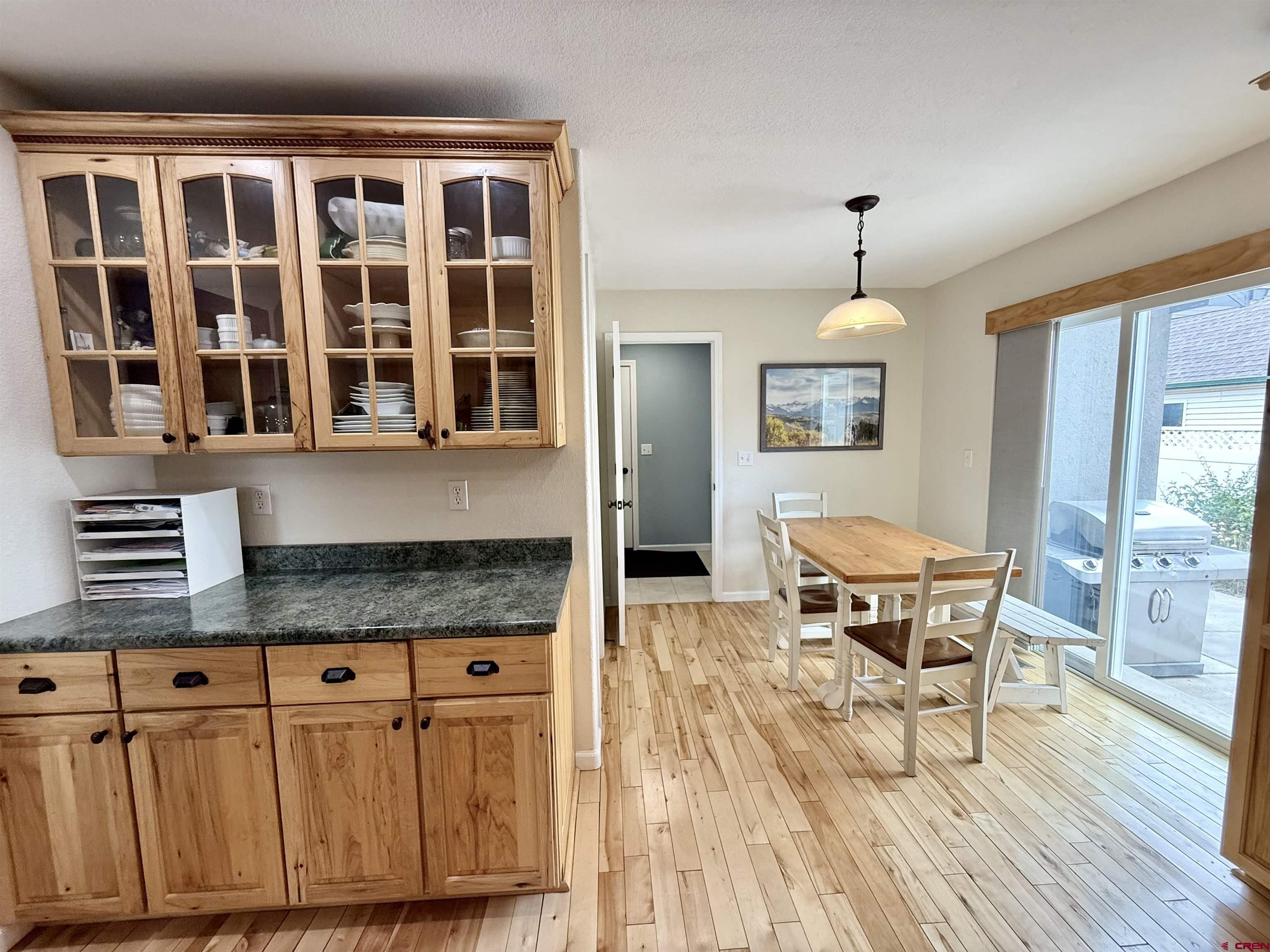 2941 Lost Creek Road North Montrose, CO 81401 - Photo 18 of 45 a kitchen with granite countertop a dining table chairs and wooden floor