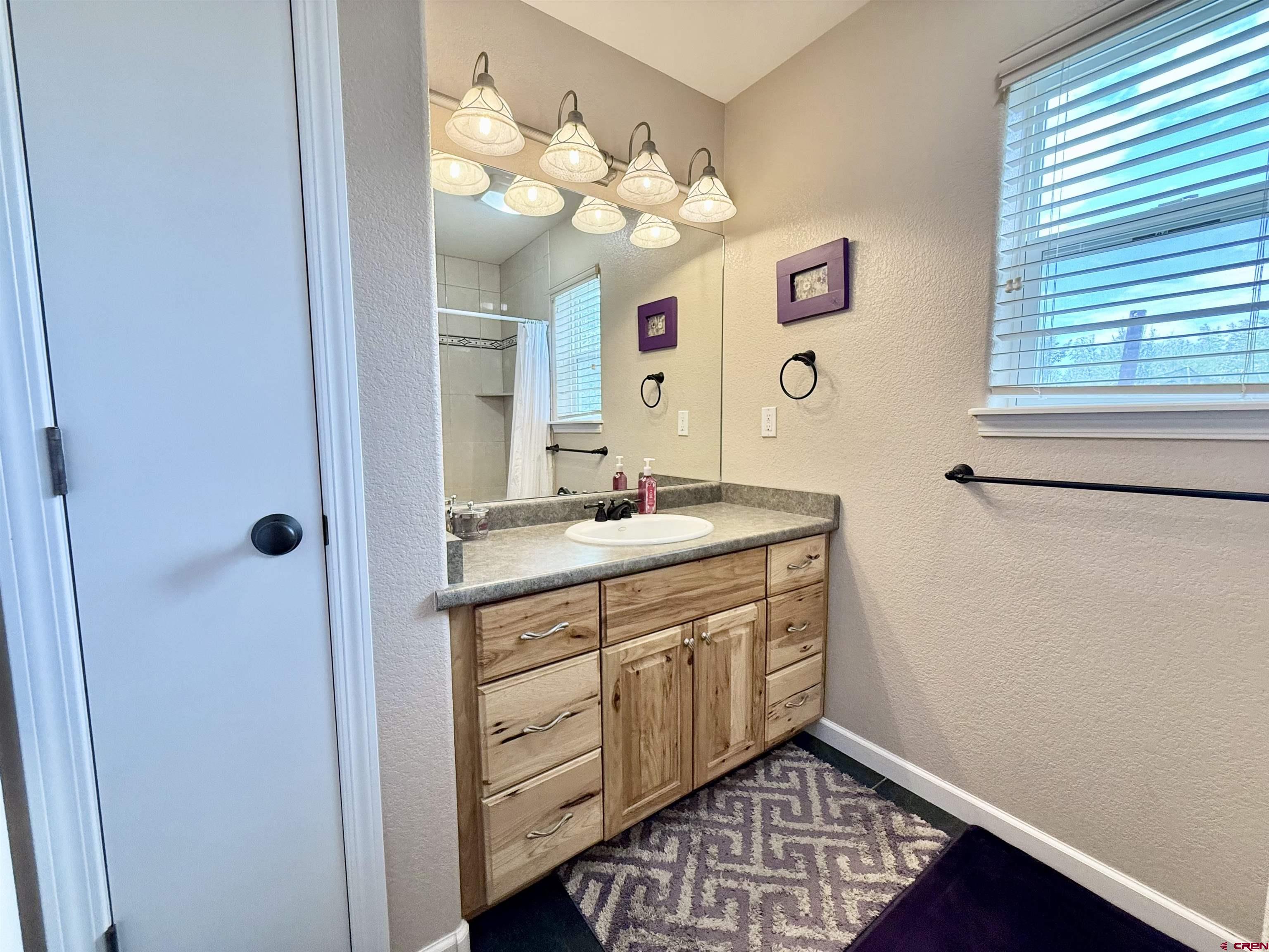 2941 Lost Creek Road North Montrose, CO 81401 - Photo 22 of 45 a spacious bathroom with a double vanity sink mirror and