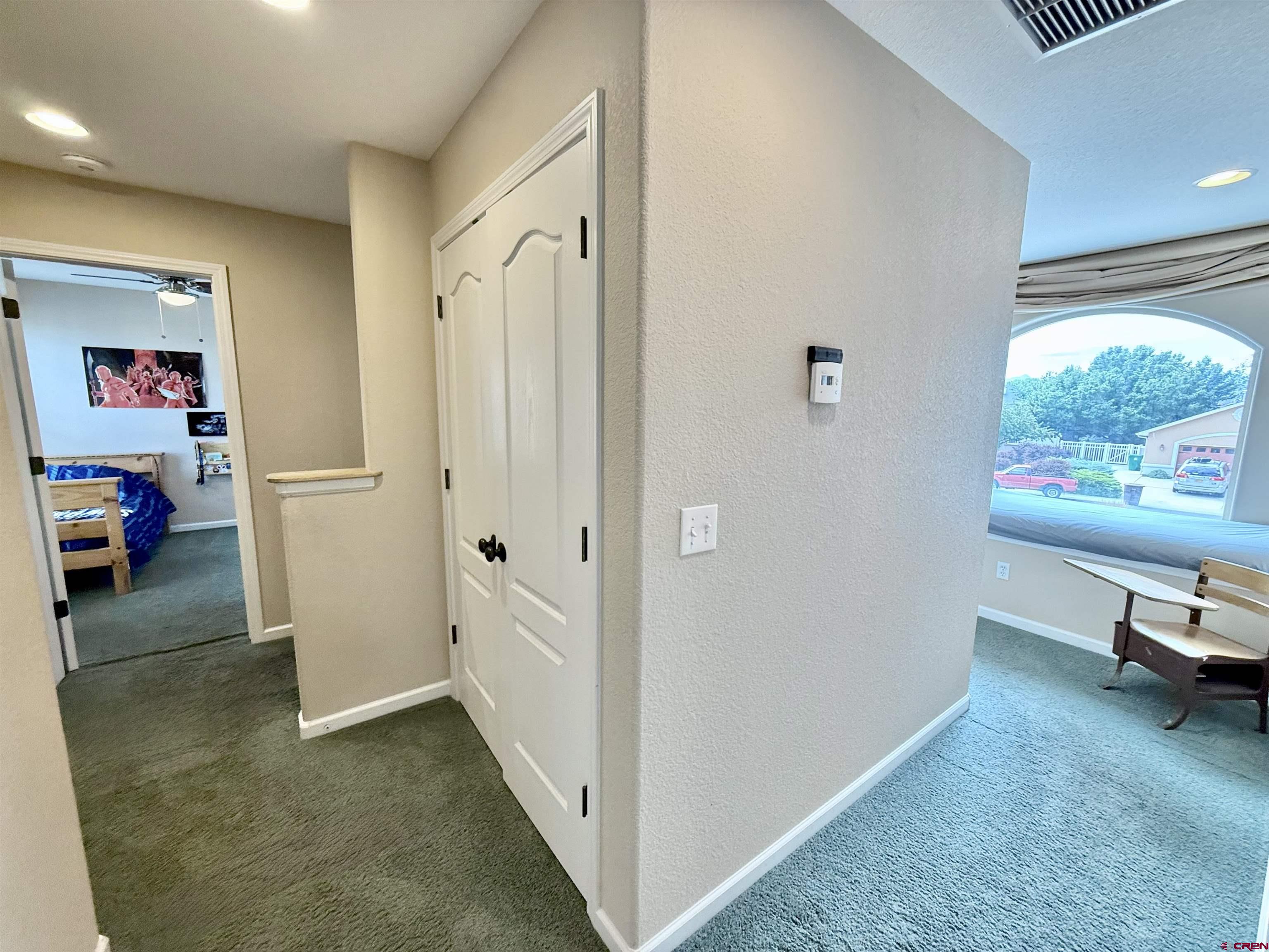 2941 Lost Creek Road North Montrose, CO 81401 - Photo 31 of 45 a view of a hallway to a livingroom with furniture