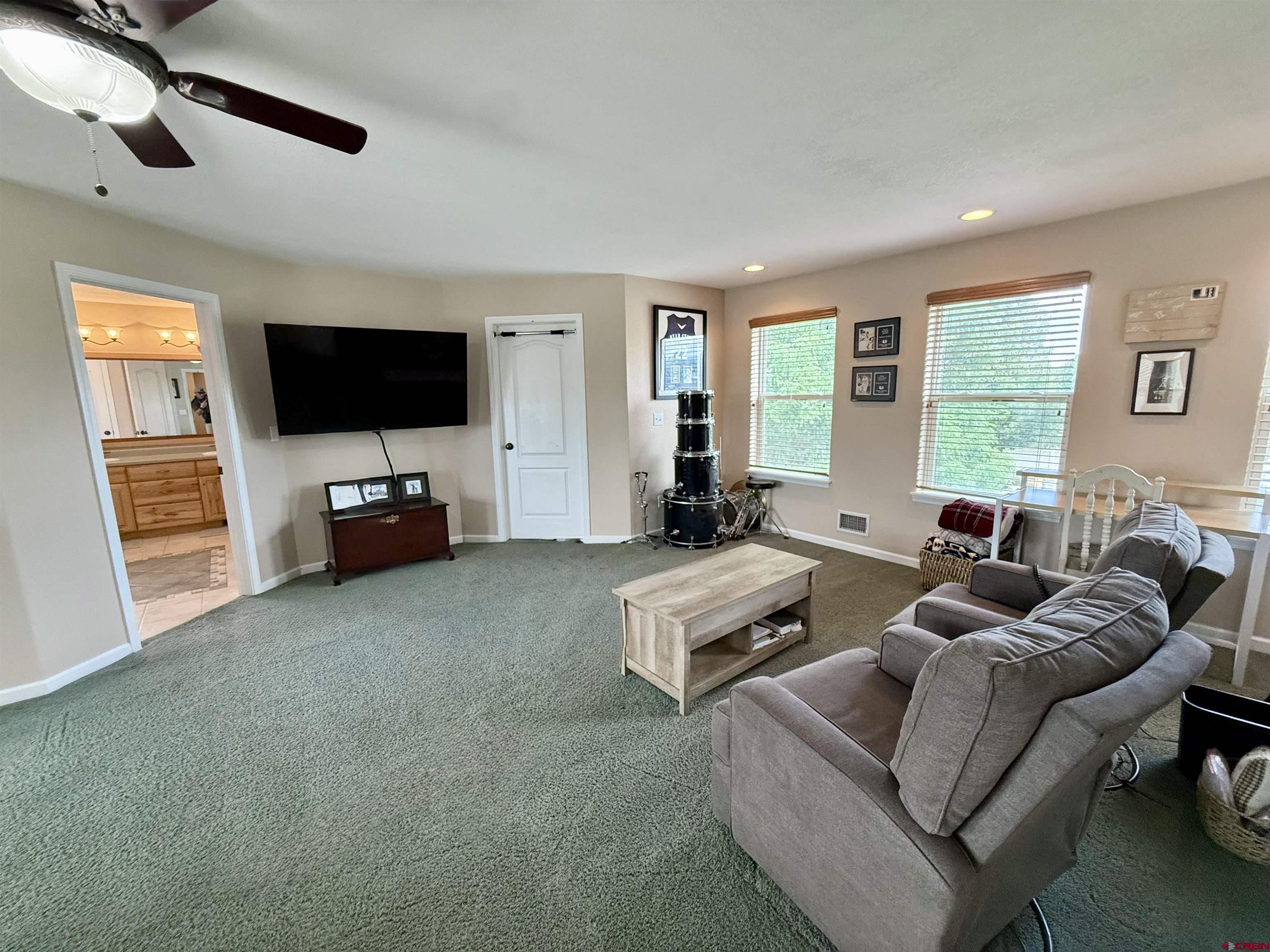 2941 Lost Creek Road North Montrose, CO 81401 - Photo 34 of 45 a living room with furniture and a flat screen tv