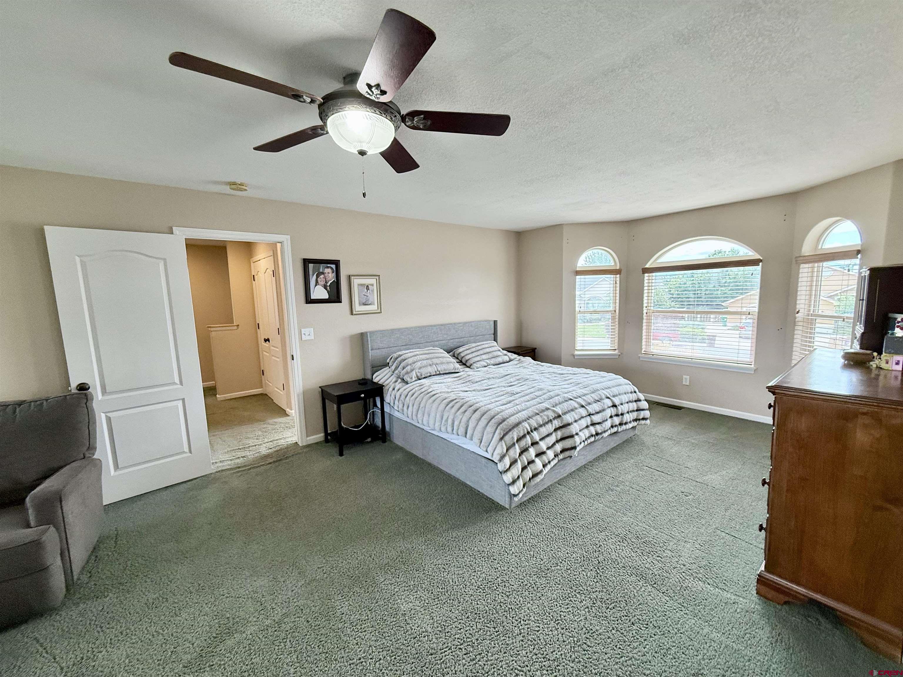2941 Lost Creek Road North Montrose, CO 81401 - Photo 37 of 45 a spacious bedroom with a bed and a large window