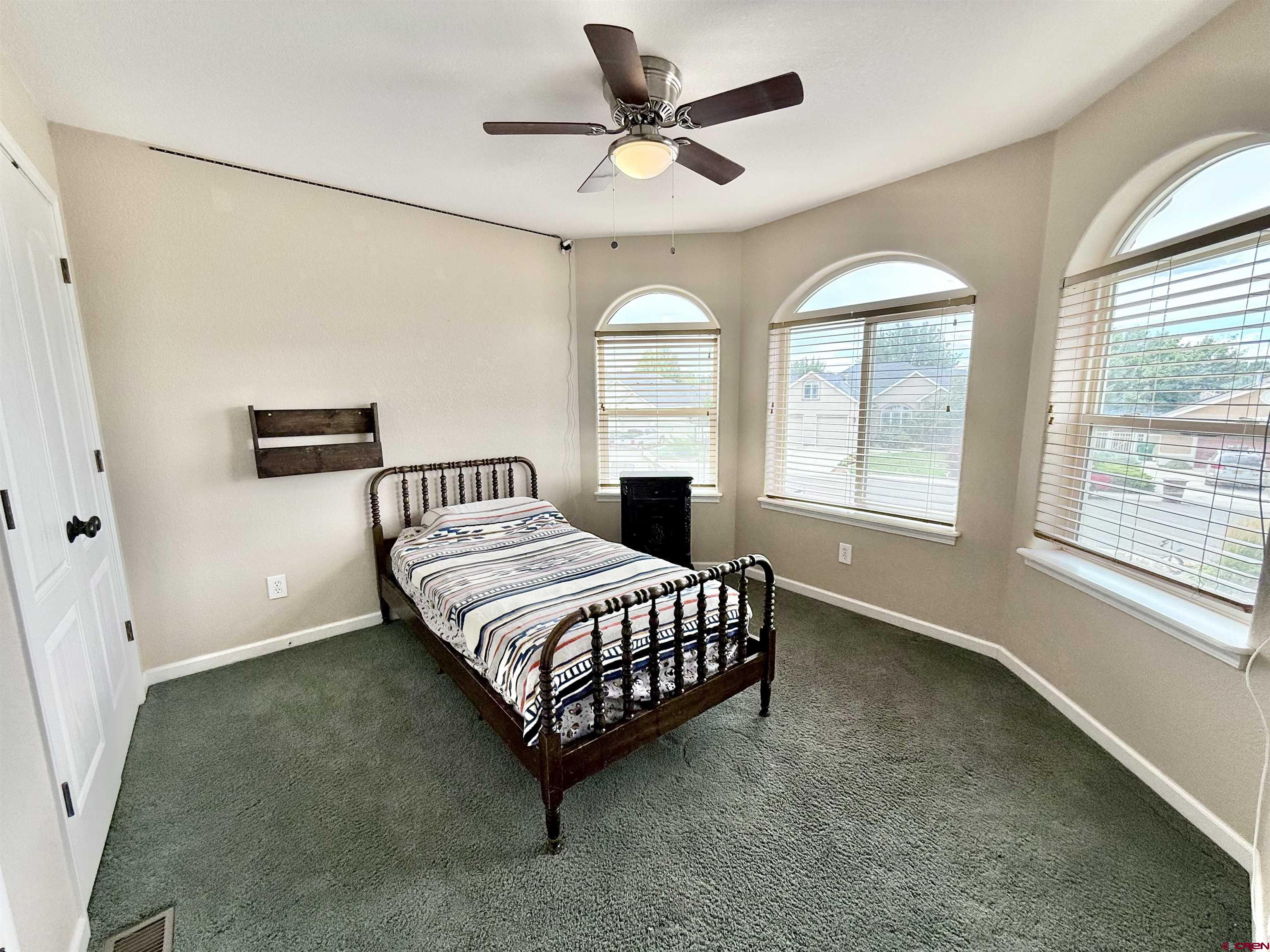 2941 Lost Creek Road North Montrose, CO 81401 - Photo 39 of 45 a bedroom with a bed chandelier and a window