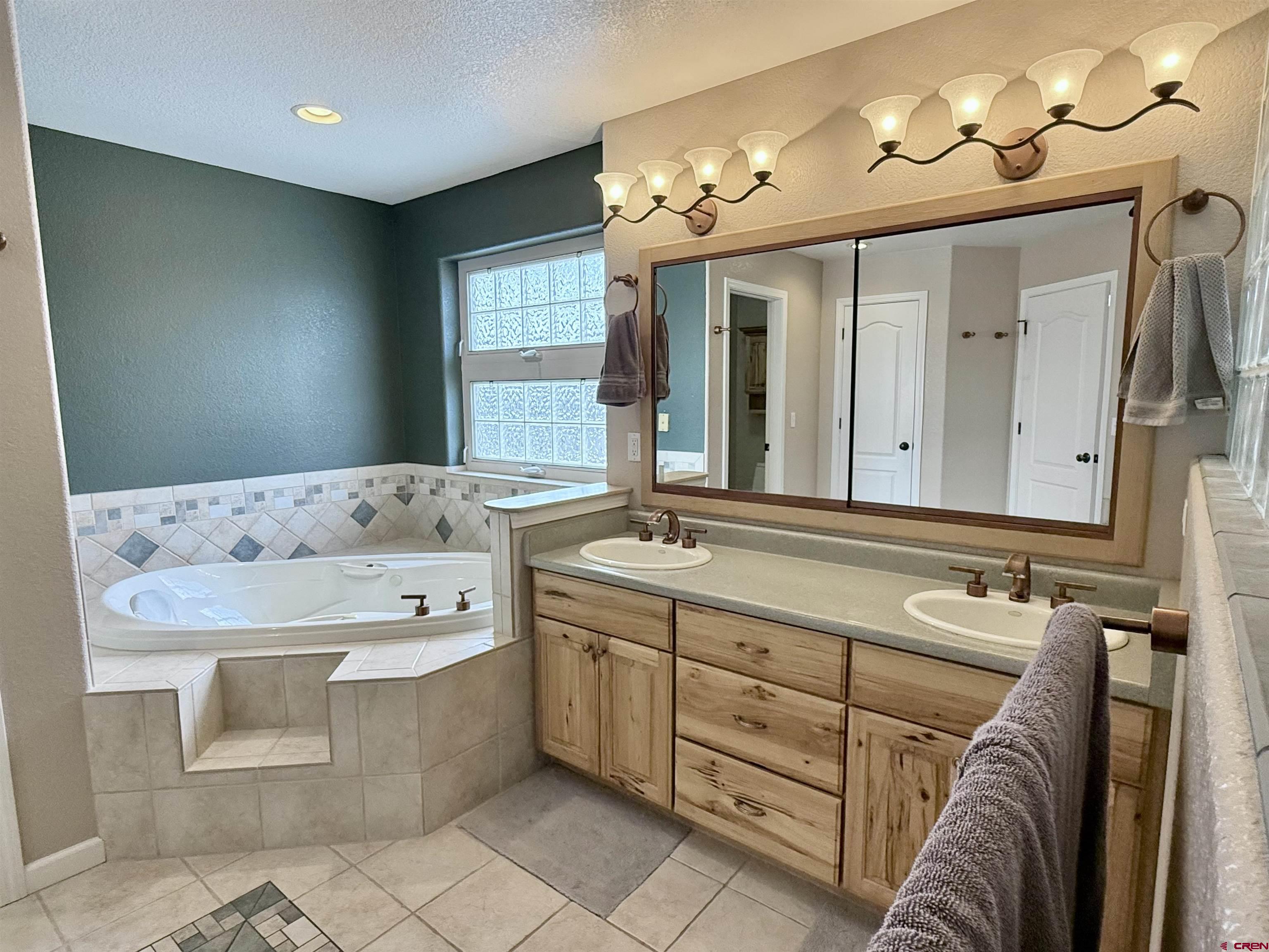 2941 Lost Creek Road North Montrose, CO 81401 - Photo 40 of 45 a bathroom with a sink double vanity and a mirror