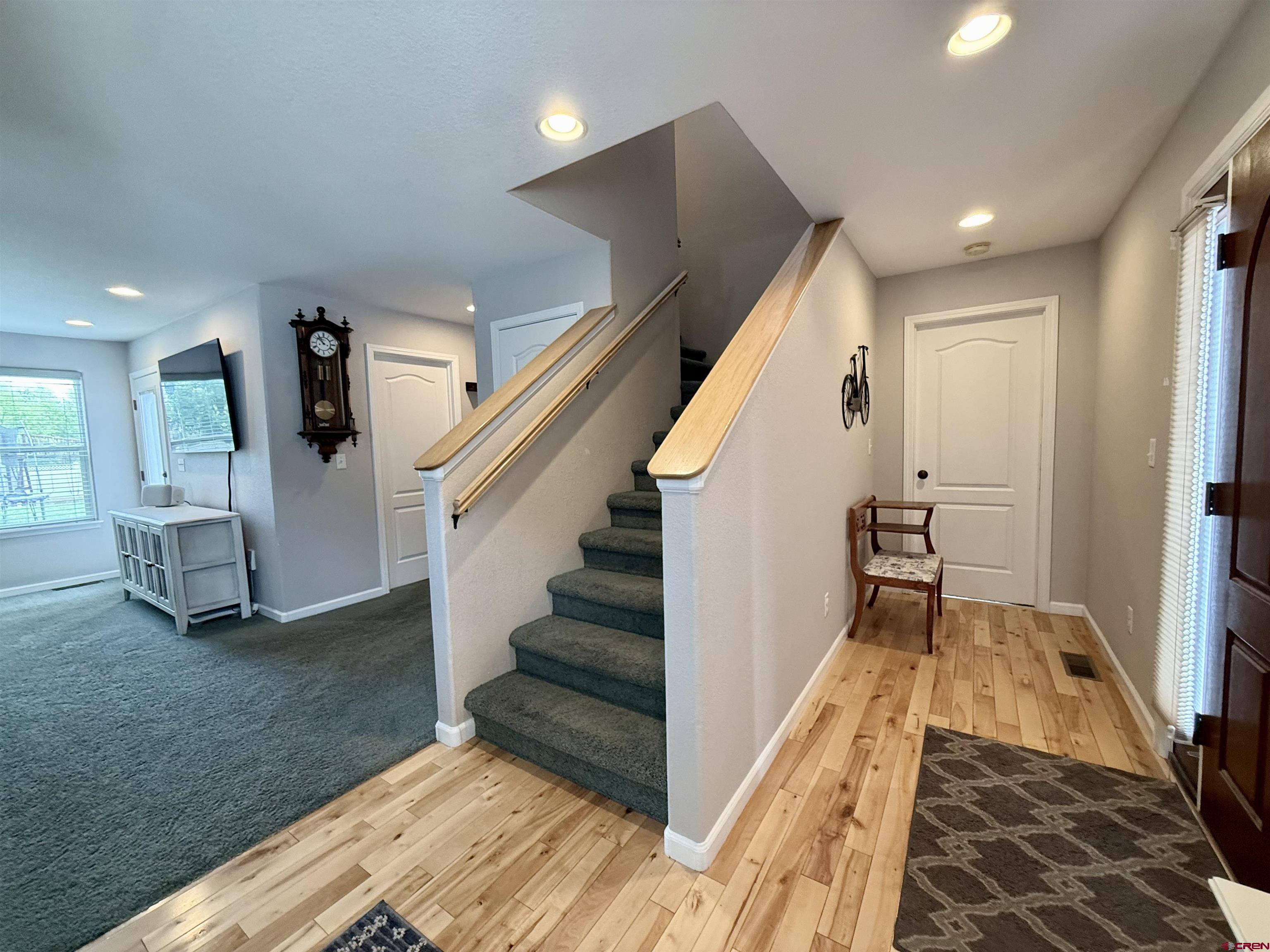 2941 Lost Creek Road North Montrose, CO 81401 - Photo 9 of 45 a view of hallway with stairs and wooden floor