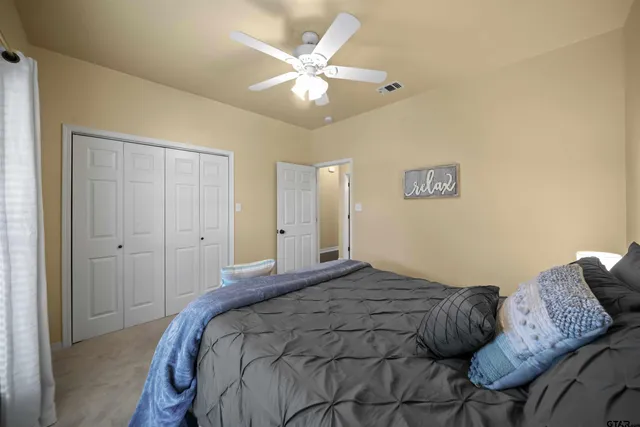 a bedroom with a bed and a chandelier