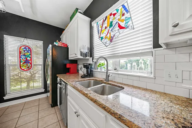 a kitchen with a table chairs and a chandelier
