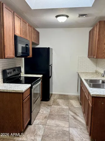 a kitchen with a stove a sink and a refrigerator