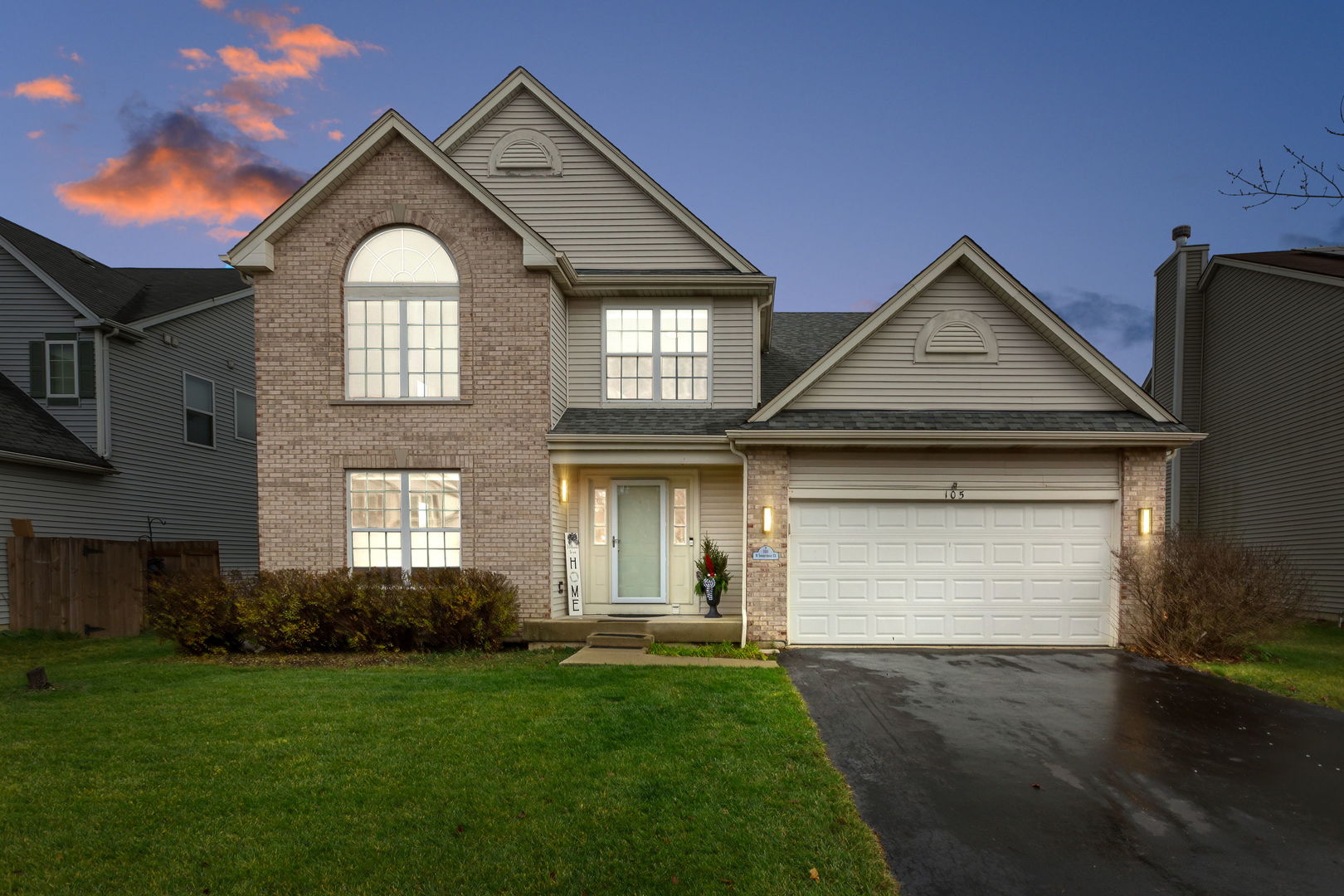 a front view of a house with a yard and garage