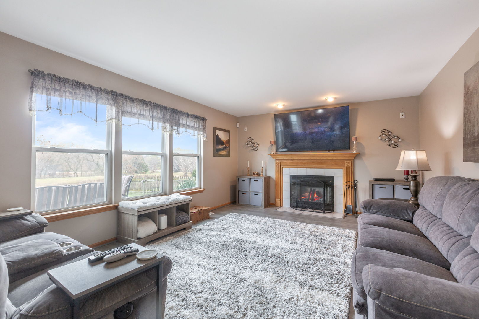 105 Inverness Court Round Lake, IL 60073 - Photo 11 of 31 a living room with furniture a fireplace and large windows