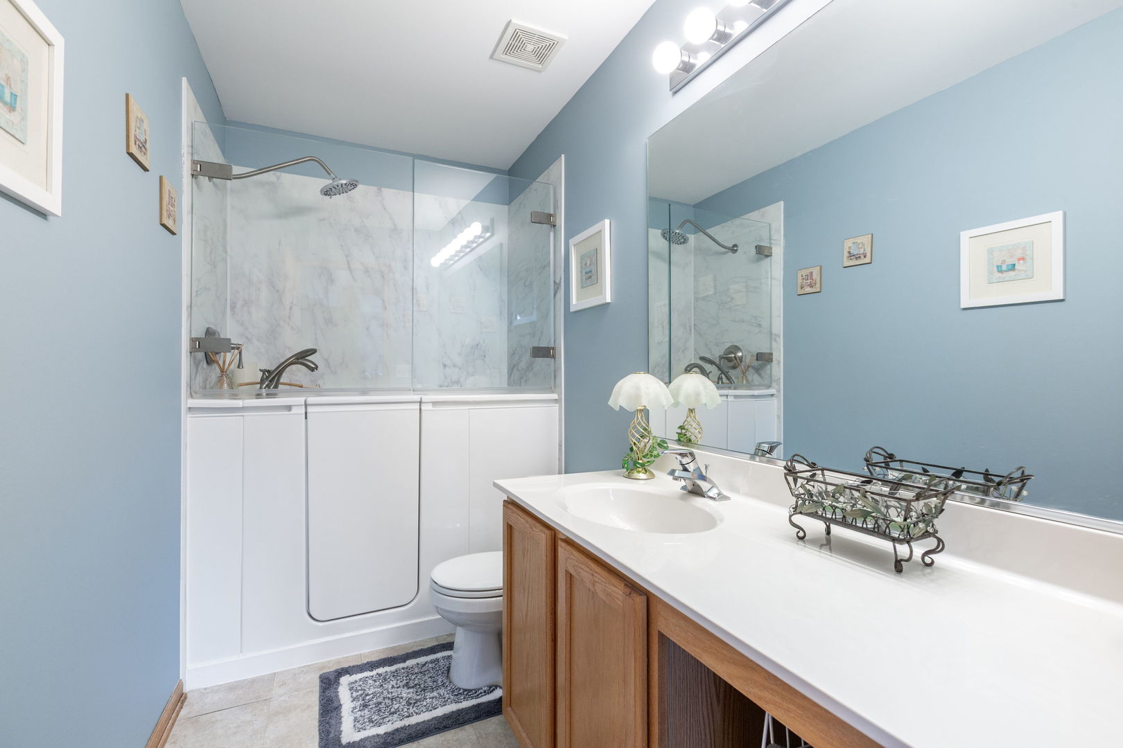 105 Inverness Court Round Lake, IL 60073 - Photo 22 of 31 a bathroom with a sink toilet and shower