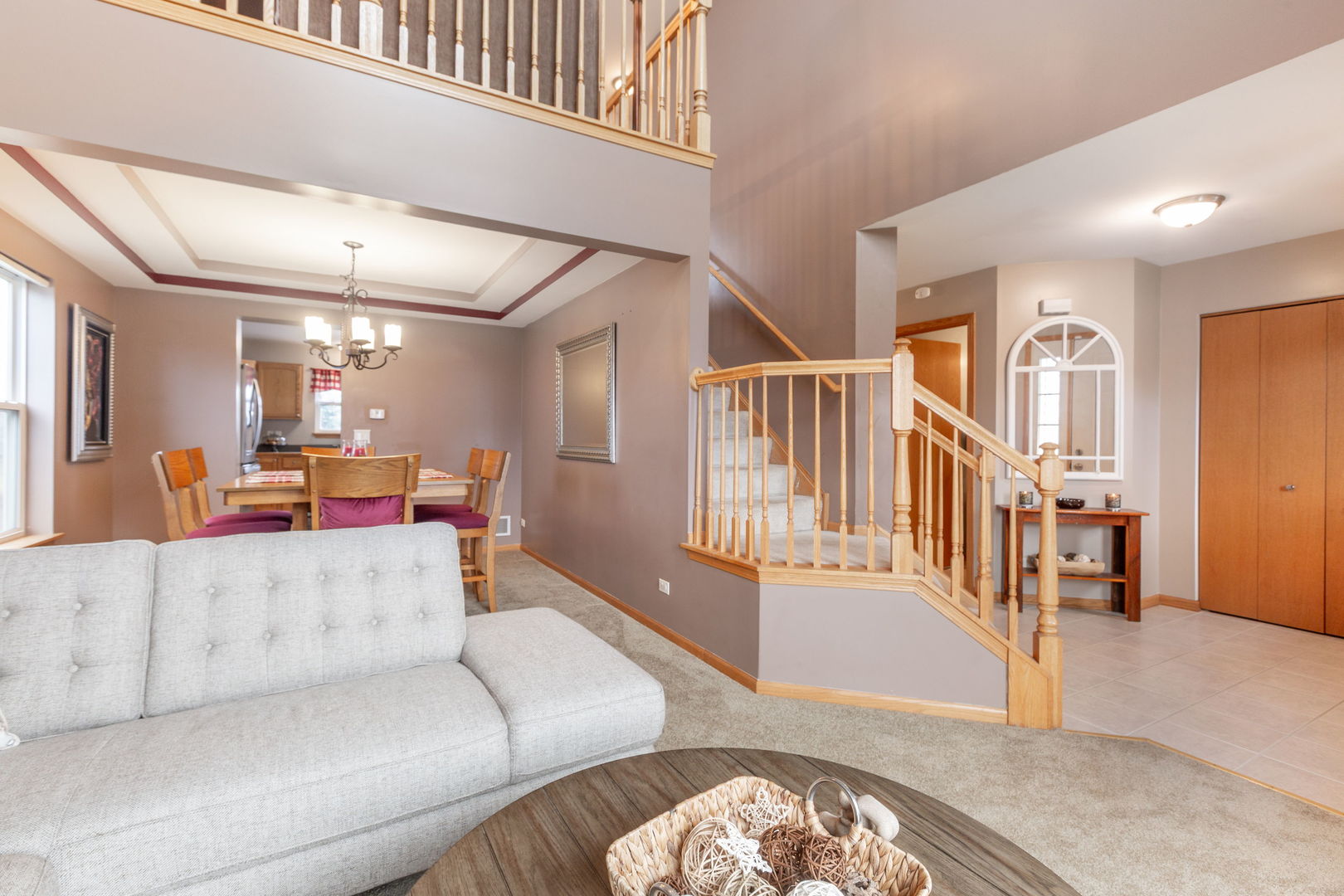 105 Inverness Court Round Lake, IL 60073 - Photo 3 of 31 a living room with furniture and a dining table with wooden floor