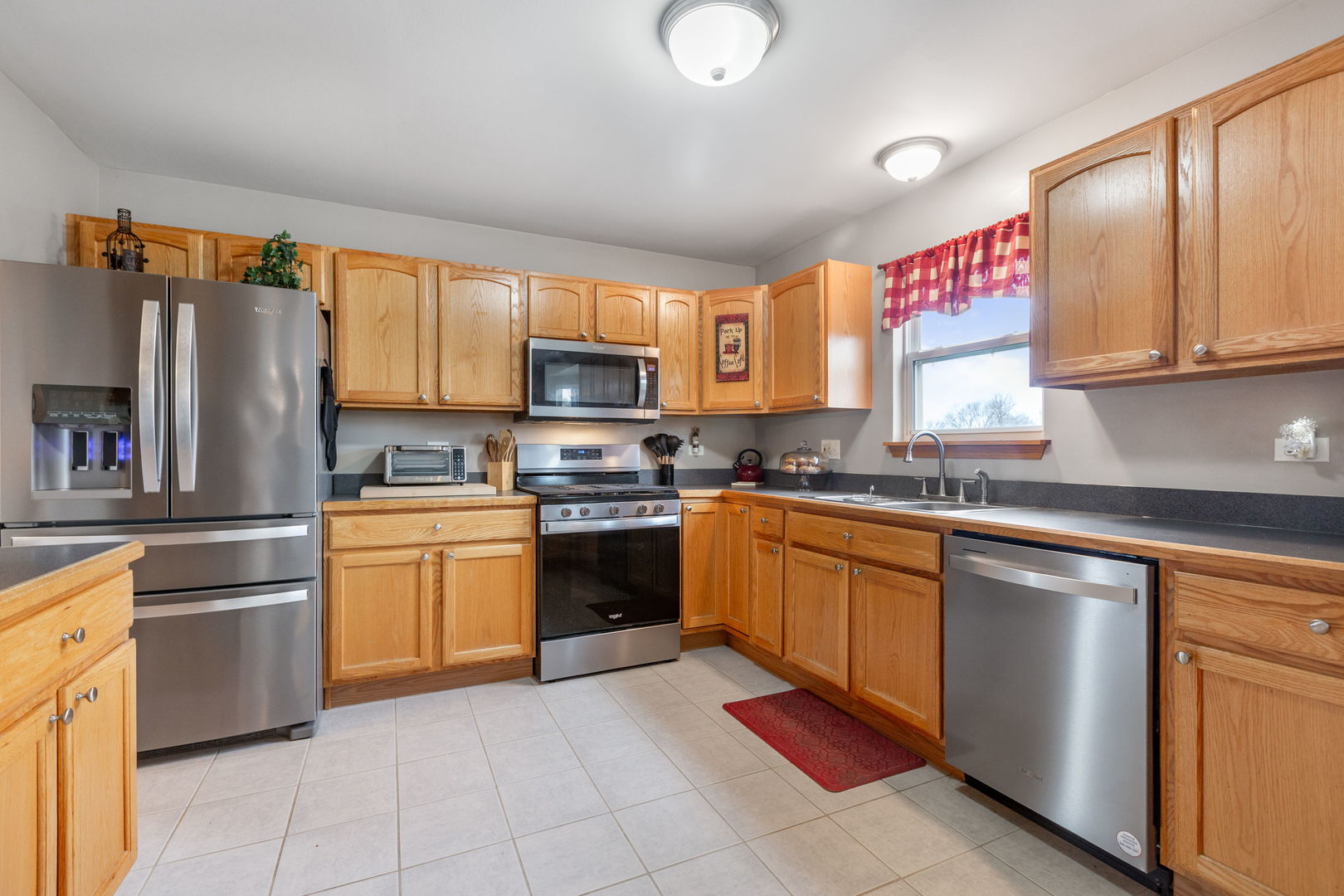 105 Inverness Court Round Lake, IL 60073 - Photo 8 of 31 a kitchen with granite countertop a sink stainless steel appliances and cabinets