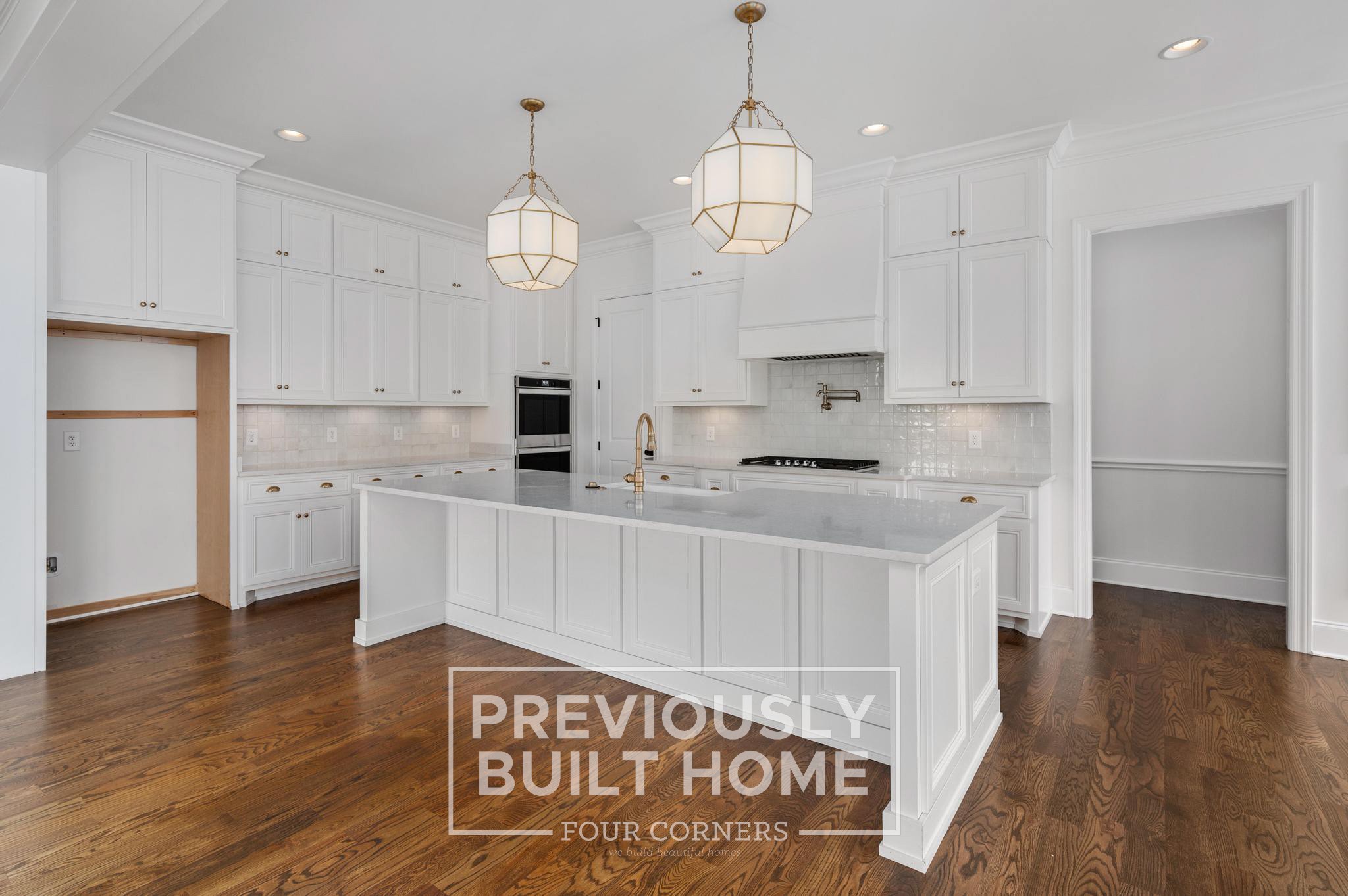 1730 Rigsby Avenue Murfreesboro, TN 37129 - Photo 9 of 22 a kitchen with stainless steel appliances kitchen island granite countertop a refrigerator a sink dishwasher a stove and white cabinets with wooden floor