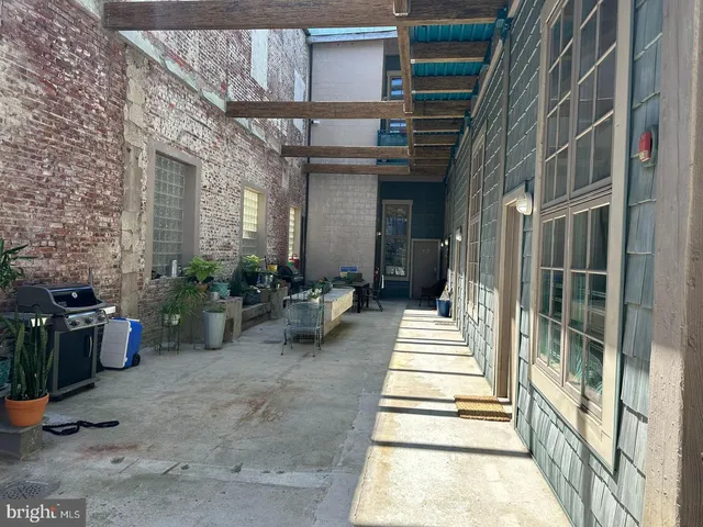 a view of a lobby with a chair and potted plants