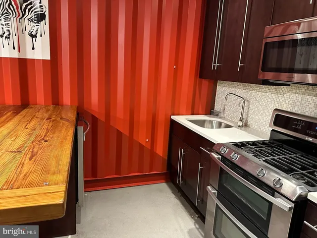 a kitchen with wooden cabinets and a stove top oven