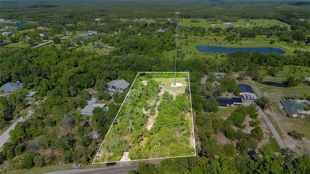 1835 South Glencoe Road New Smyrna Beach, FL 32168 - Photo 1 of 29 an aerial view of residential houses with outdoor space and trees