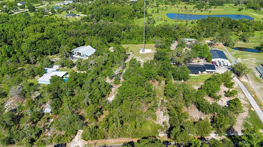 1835 South Glencoe Road New Smyrna Beach, FL 32168 - Photo 13 of 29 an aerial view of residential house with outdoor space and trees all around