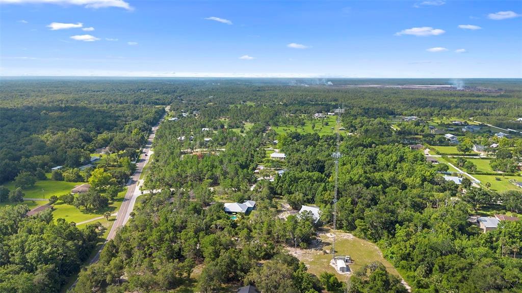 1835 South Glencoe Road New Smyrna Beach, FL 32168 - Photo 26 of 29 an aerial view of residential houses with outdoor space and trees