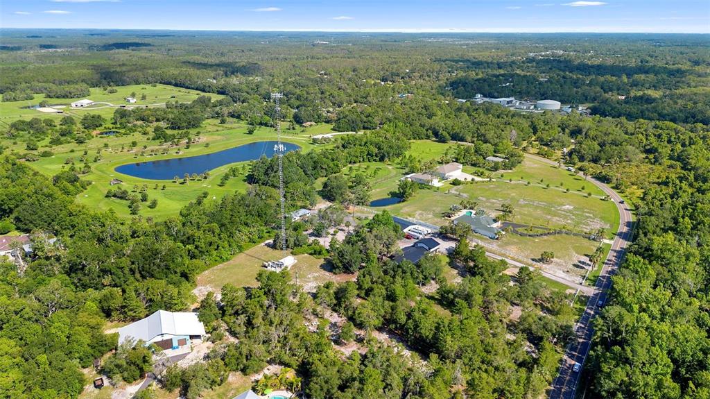 1835 South Glencoe Road New Smyrna Beach, FL 32168 - Photo 3 of 29 an aerial view of residential houses with outdoor space and trees