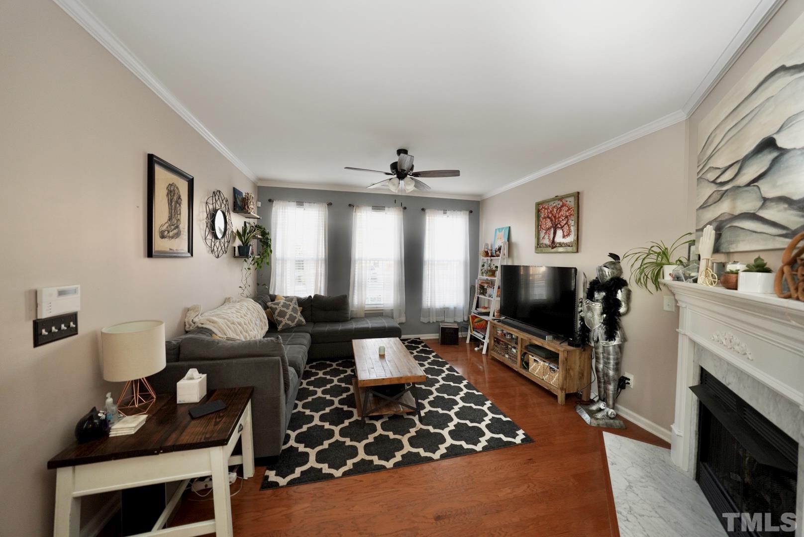 7825 Silverthread Lane Raleigh, NC 27617 - Photo 2 of 8 a living room with furniture a flat screen tv and a fireplace