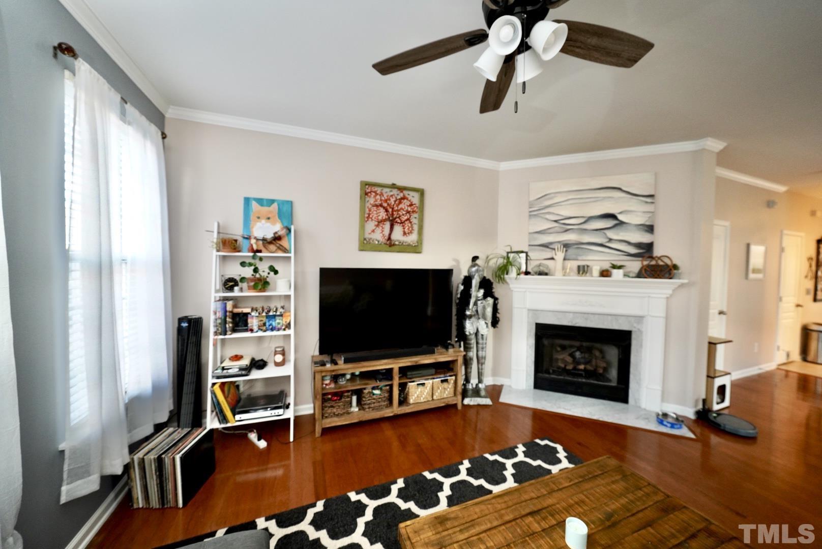 7825 Silverthread Lane Raleigh, NC 27617 - Photo 3 of 8 a living room with furniture and a flat screen tv