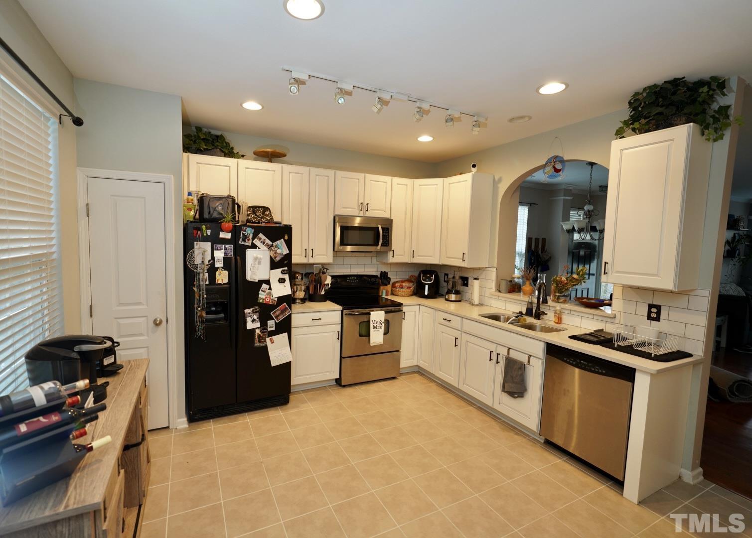 7825 Silverthread Lane Raleigh, NC 27617 - Photo 5 of 8 a kitchen with refrigerator and cabinets