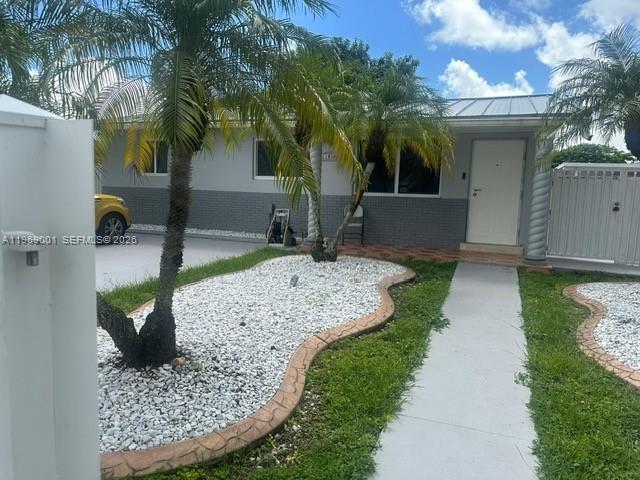 a view of a backyard house with large trees and plants