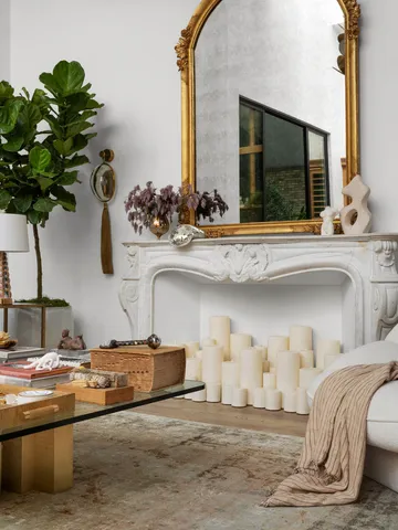 a living room with furniture a fireplace and a large window
