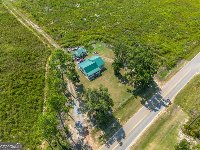 a view of a house with a yard and sitting area