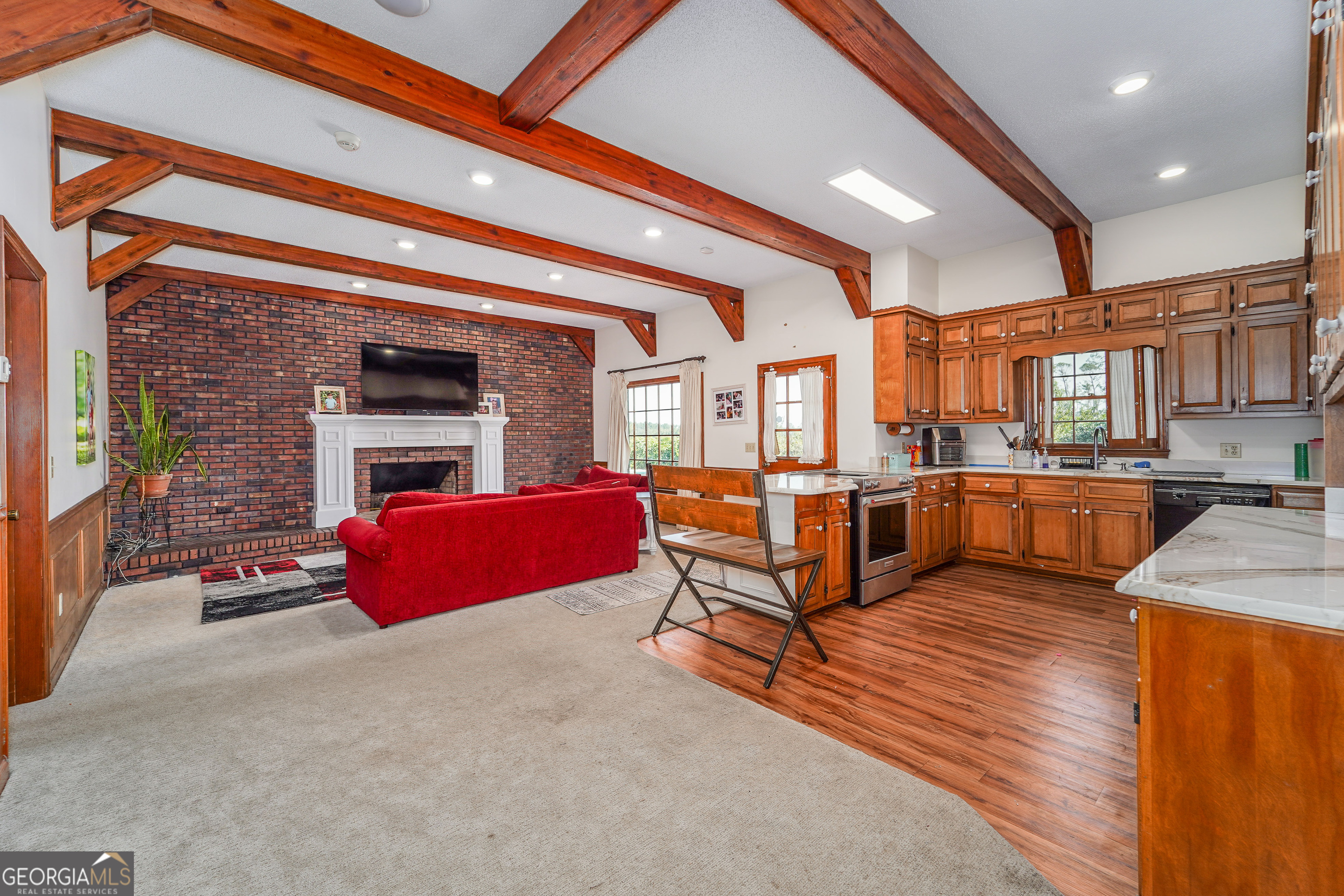 1671 Warren Carter Road Douglas, GA 31533 - Photo 35 of 57 a living room with furniture a kitchen view and a fireplace