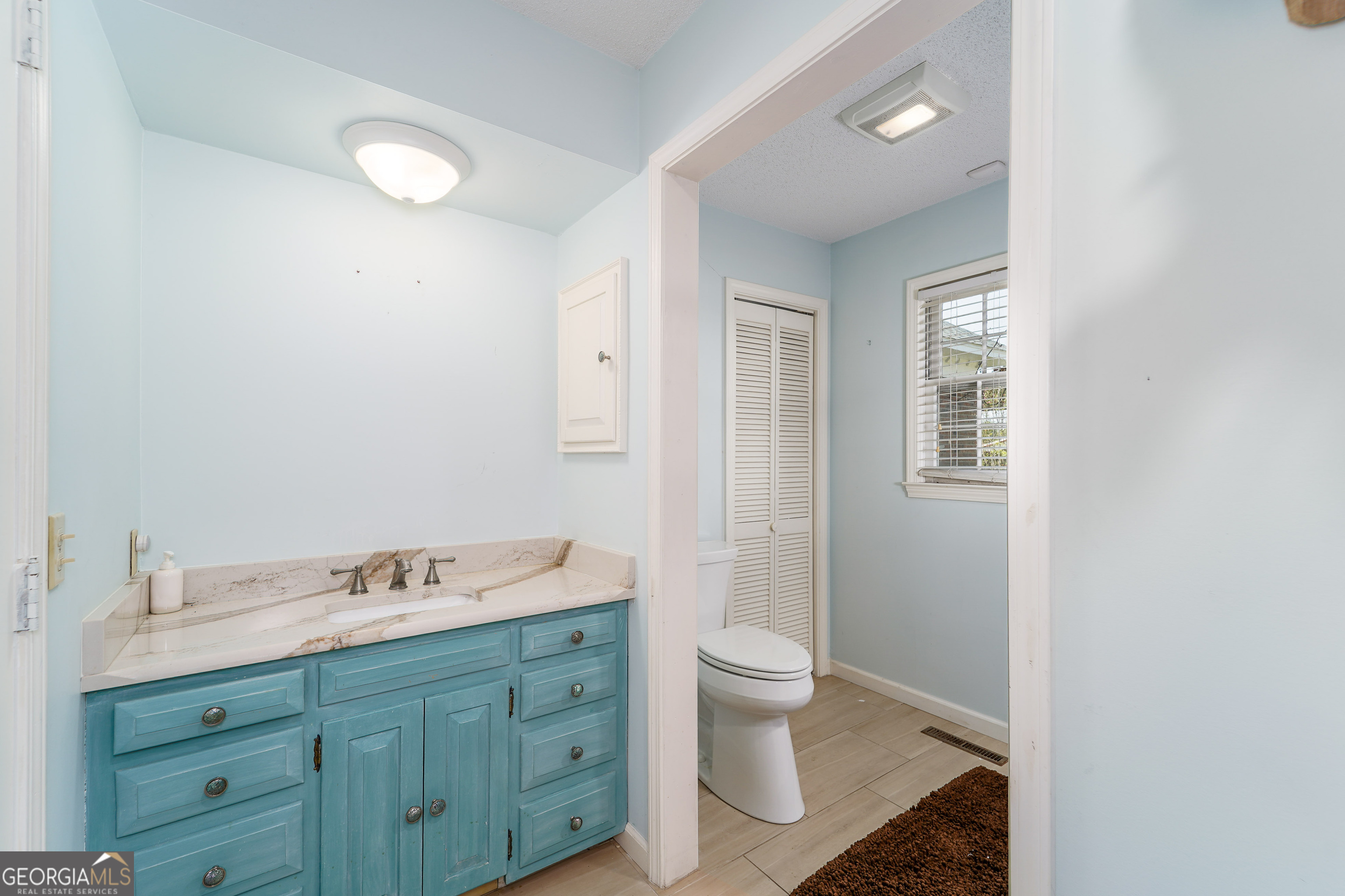 1671 Warren Carter Road Douglas, GA 31533 - Photo 43 of 57 a spacious bathroom with a double vanity sink toilet and shower