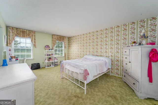 a bathroom with a sink a toilet a mirror and shower