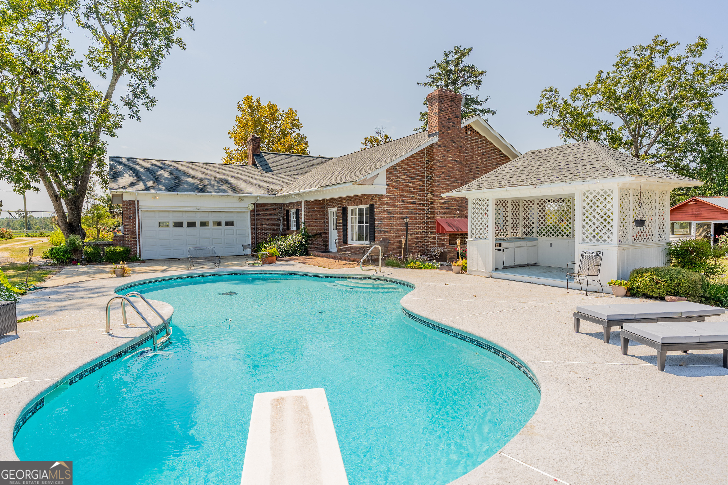 1671 Warren Carter Road Douglas, GA 31533 - Photo 5 of 57 a view of a house with a porch and a swimming pool