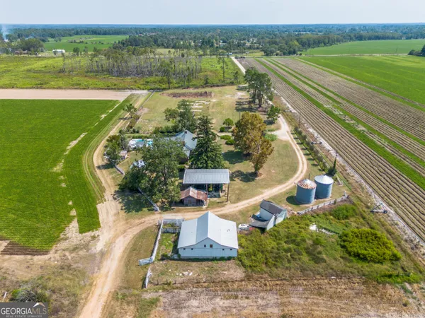 an aerial view of a house with a big yard