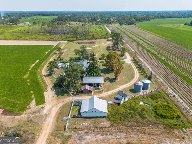 an aerial view of a house with a big yard