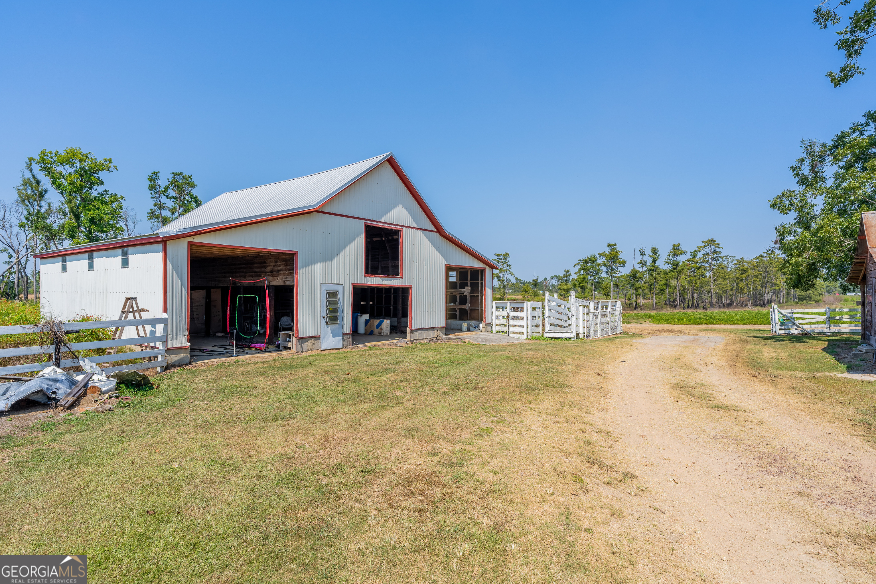 1671 Warren Carter Road Douglas, GA 31533 - Photo 10 of 57 a view of house with outdoor space and swimming pool