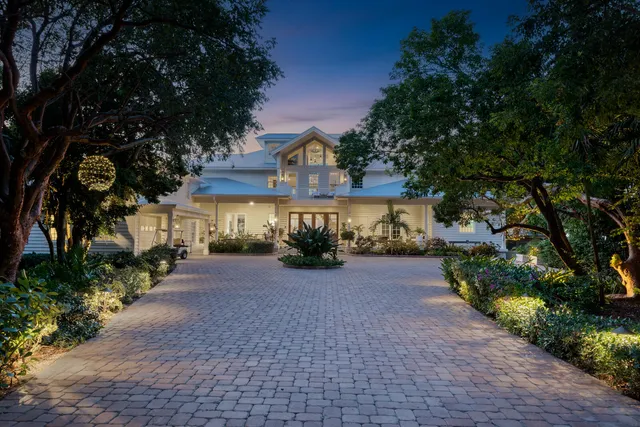 a front view of a house with yard and green space