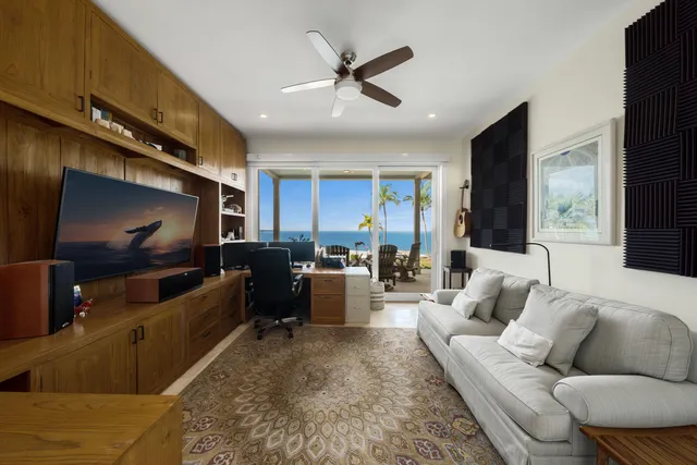 a view of a house with a yard and potted plants