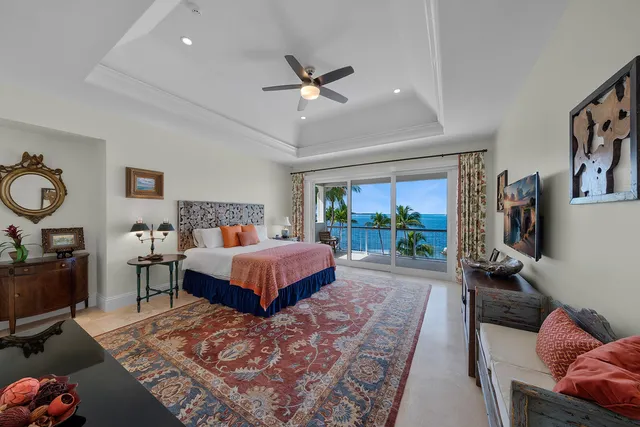 a kitchen with stainless steel appliances a dining table chairs refrigerator and cabinets