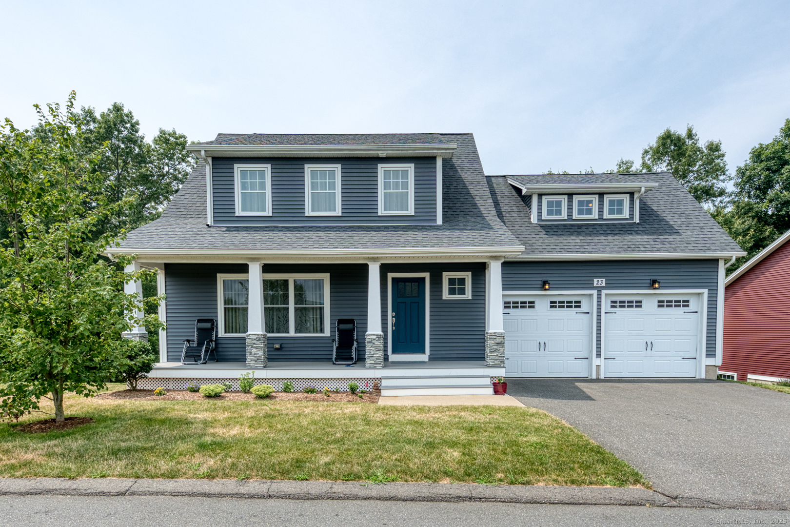 a view of a white house with a large pool in front of it