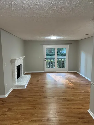 wooden floor in an empty room with a fireplace