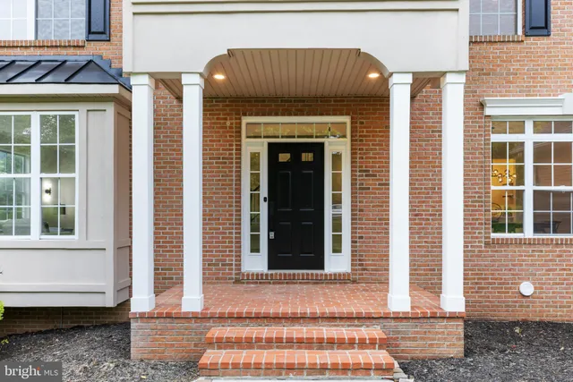 a kitchen with a table chairs refrigerator and cabinets