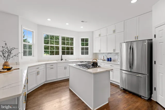 a living room with furniture and large windows