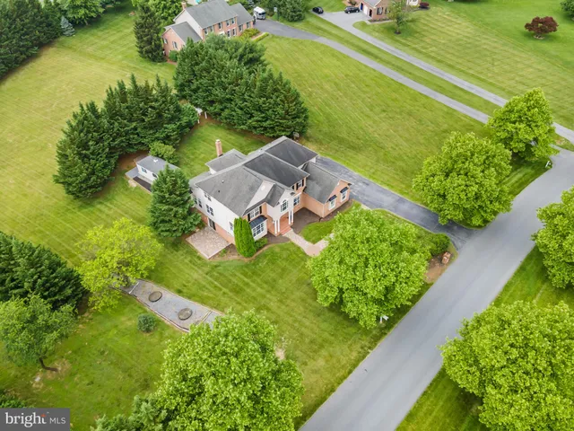 an aerial view of a house with a yard and lake view