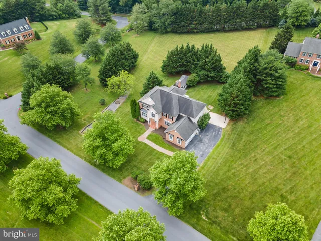 an aerial view of a house with a yard swimming pool outdoor seating and yard