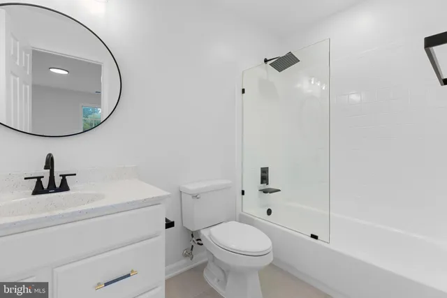 a living room with furniture a large window and wooden floor