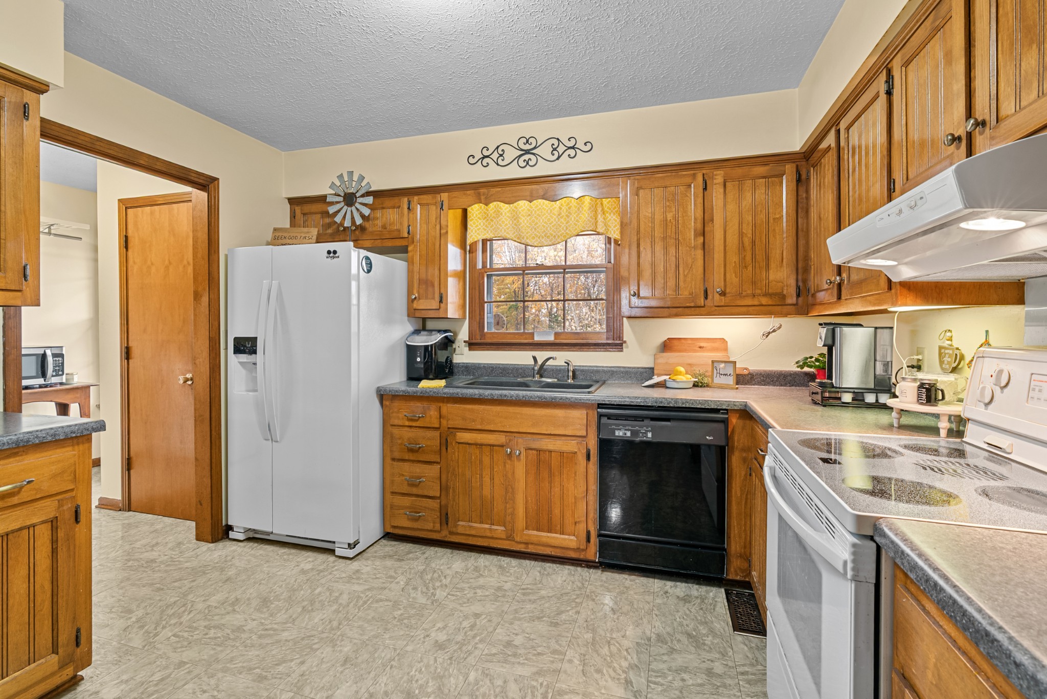 6980 Bethel Road Greenbrier, TN 37073 - Photo 17 of 51 a kitchen with stainless steel appliances granite countertop a refrigerator a sink dishwasher a stove and a microwave oven with cabinets
