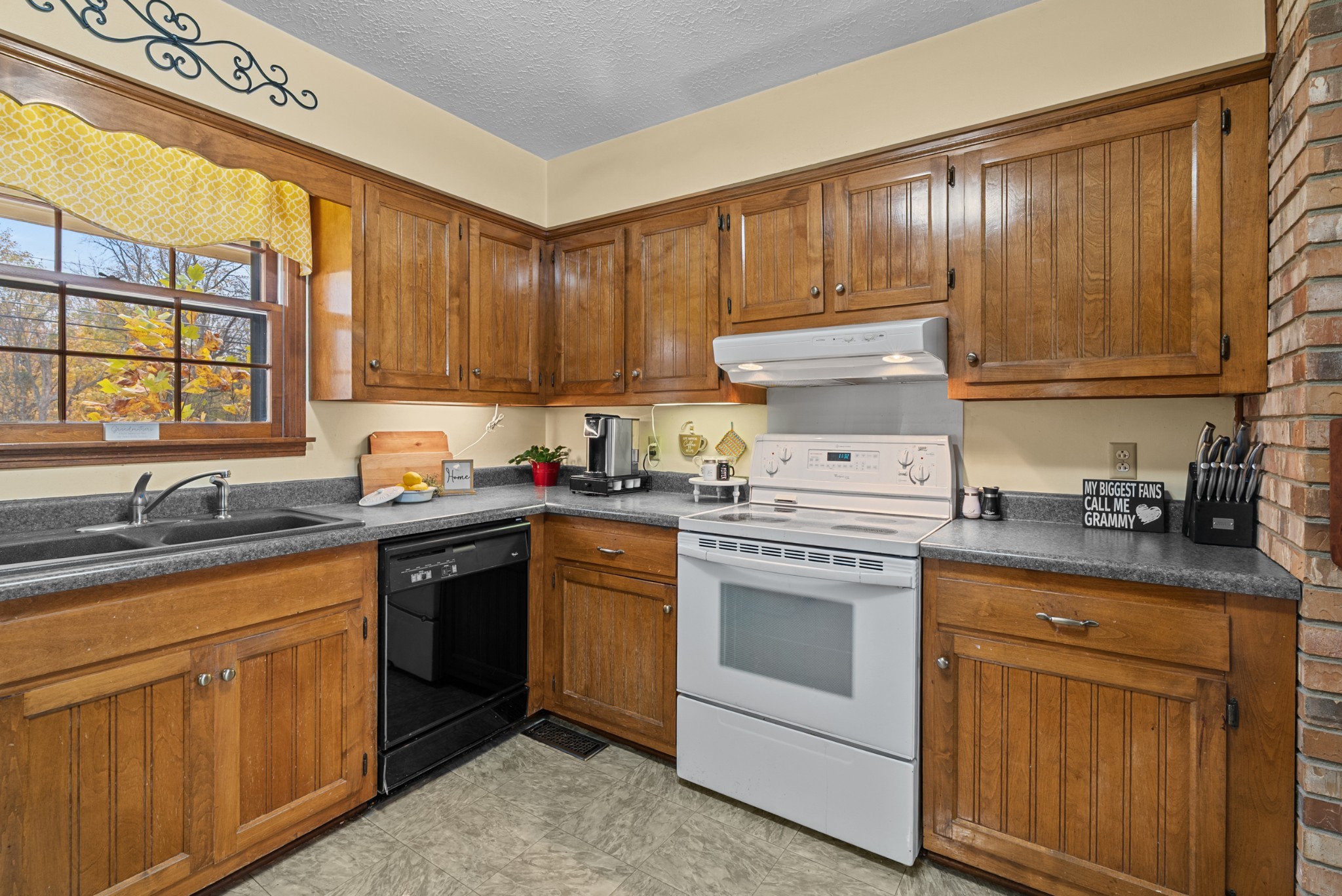 6980 Bethel Road Greenbrier, TN 37073 - Photo 19 of 51 a kitchen with granite countertop cabinets stainless steel appliances a sink and window